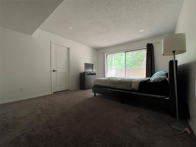 bedroom featuring baseboards, carpet, and a textured ceiling