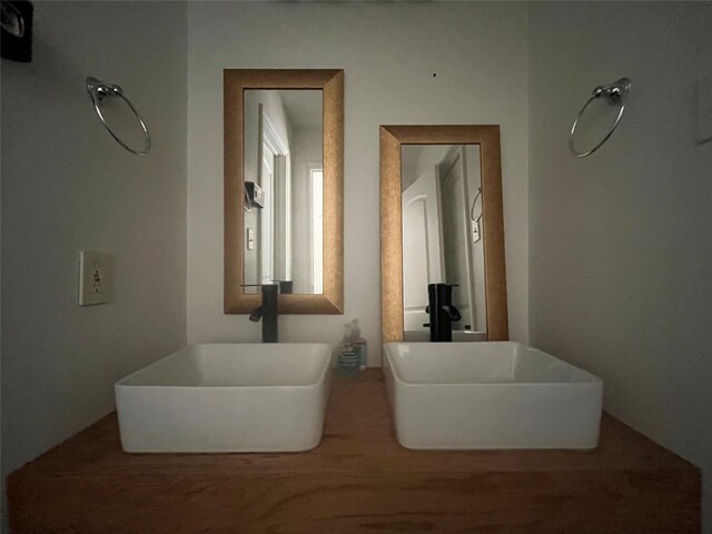 full bathroom with a sink and a soaking tub