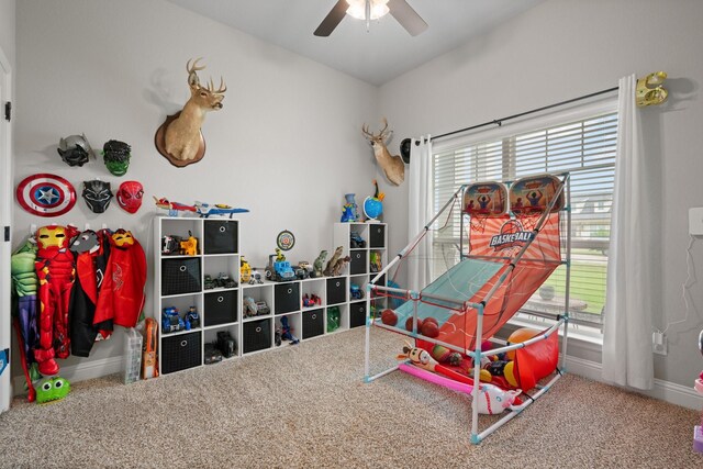 game room with baseboards, carpet, and ceiling fan