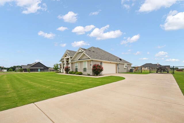 view of side of home featuring a lawn, fence, and driveway