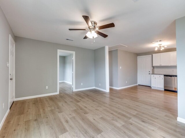 unfurnished living room with light wood-style floors, baseboards, a ceiling fan, and attic access