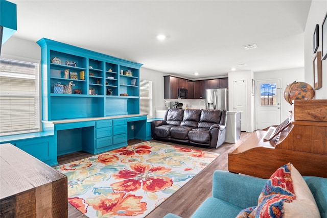 living room featuring visible vents, recessed lighting, and wood finished floors