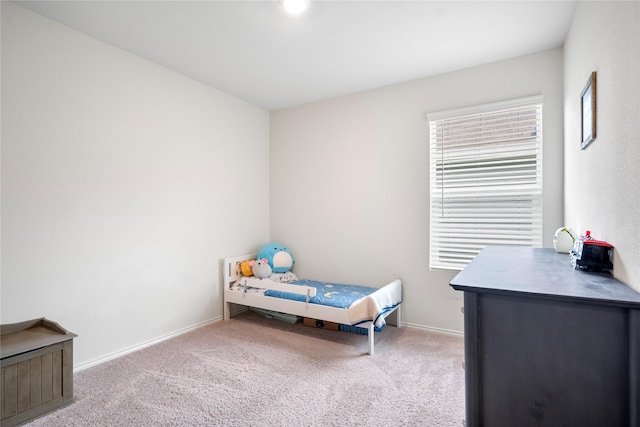 carpeted bedroom with baseboards