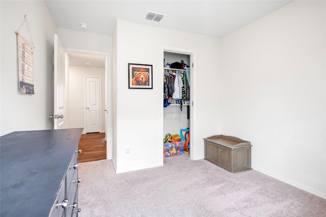 bedroom featuring baseboards, carpet, a closet, and visible vents