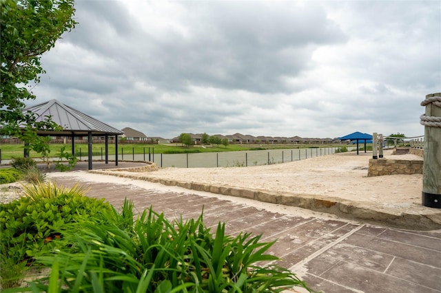 surrounding community with a gazebo, fence, and a residential view