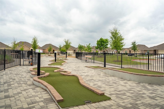 view of community featuring fence and a residential view