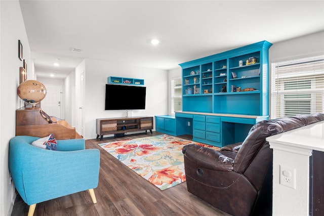 living area with built in study area, recessed lighting, light wood-style flooring, and visible vents