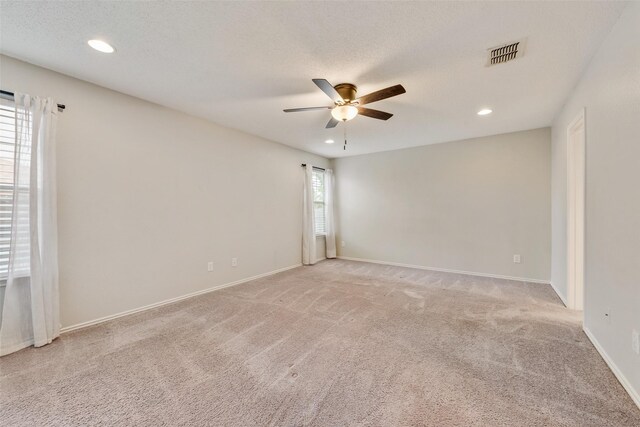 unfurnished room featuring light colored carpet, a ceiling fan, and recessed lighting