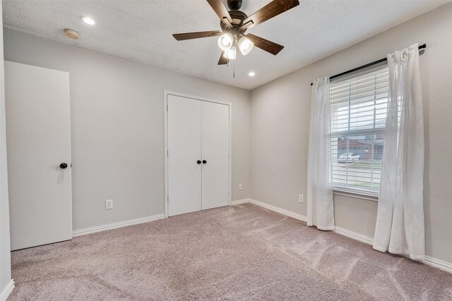 unfurnished bedroom featuring recessed lighting, baseboards, and carpet