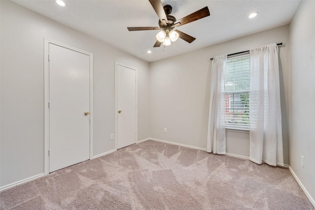 unfurnished bedroom featuring carpet floors, recessed lighting, baseboards, and a ceiling fan