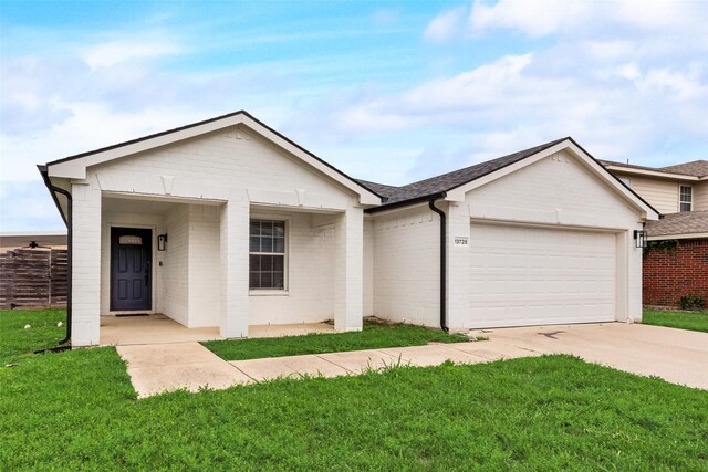 ranch-style home featuring brick siding, an attached garage, driveway, and a front lawn
