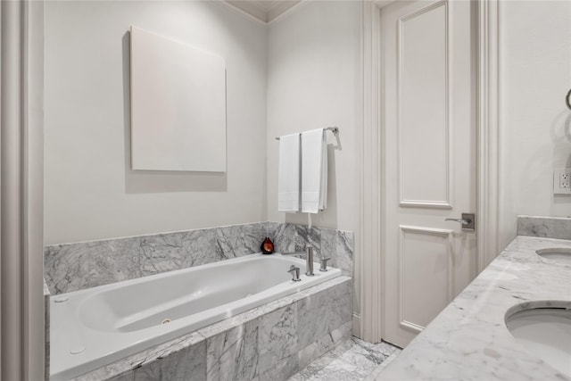 full bath featuring a sink, ornamental molding, a garden tub, and double vanity