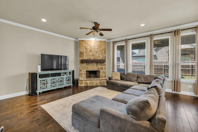 living room featuring baseboards, ornamental molding, ceiling fan, and hardwood / wood-style flooring