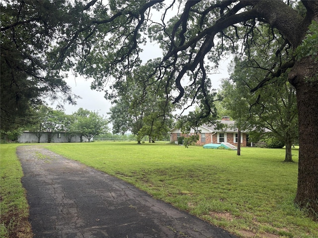 view of property's community with a lawn