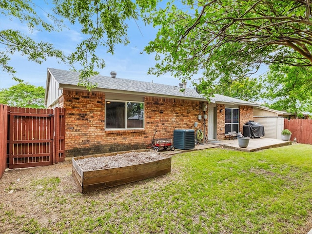 back of property with a patio, a fenced backyard, central AC unit, a gate, and a lawn