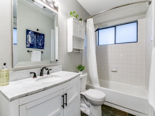 bathroom featuring vanity, a textured wall, shower / bath combination with curtain, and toilet