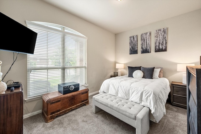 carpeted bedroom featuring baseboards