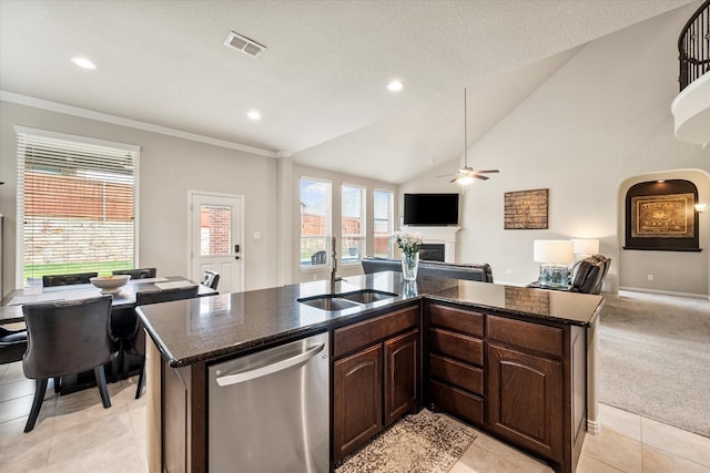 kitchen featuring a sink, a fireplace, open floor plan, stainless steel dishwasher, and visible vents
