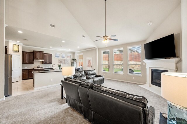 living room with ceiling fan, light colored carpet, a glass covered fireplace, recessed lighting, and visible vents