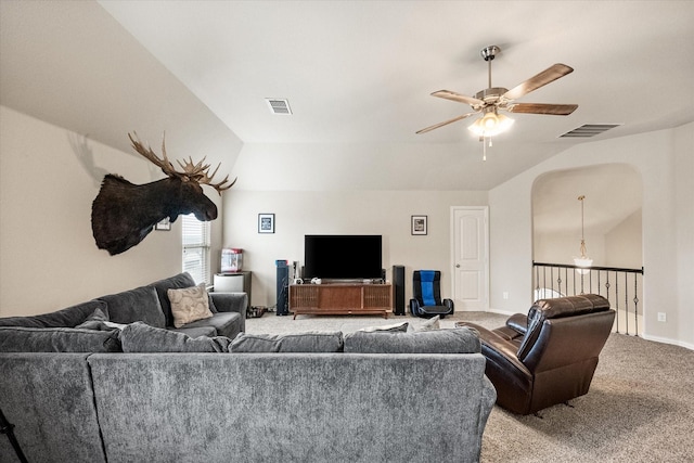 living room with light colored carpet, a ceiling fan, visible vents, and vaulted ceiling