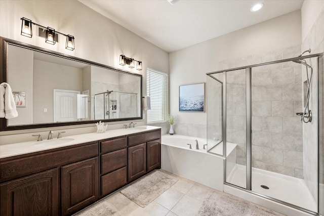 bathroom featuring a sink, double vanity, a shower stall, and a garden tub
