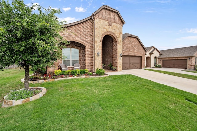 view of front facade featuring brick siding, a garage, a front yard, and concrete driveway