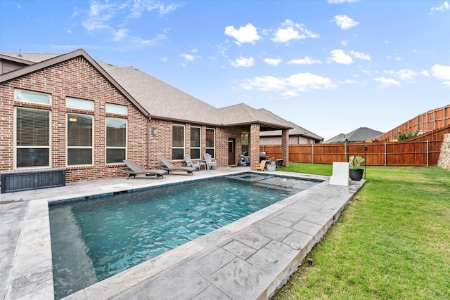 view of swimming pool featuring a lawn, a patio, a fenced in pool, and a fenced backyard