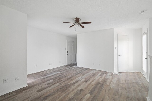 unfurnished room featuring baseboards, ceiling fan, and wood finished floors