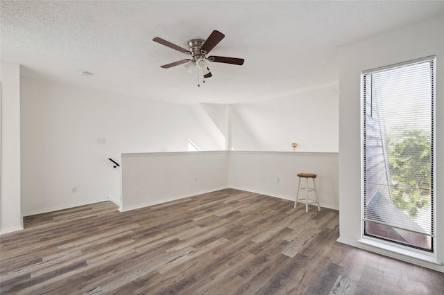 unfurnished room with baseboards, a ceiling fan, and wood finished floors