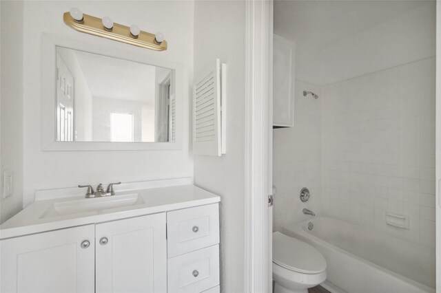 bathroom featuring vanity, shower / bathing tub combination, and toilet