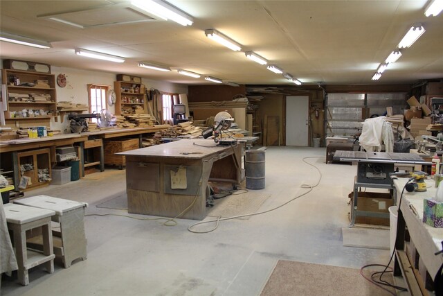 miscellaneous room featuring a workshop area and concrete floors