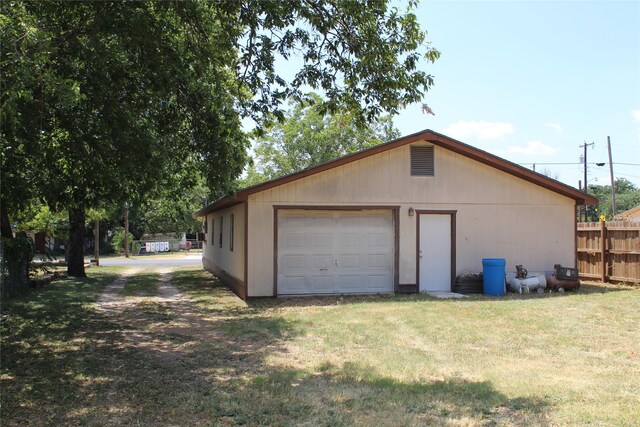 detached garage featuring fence