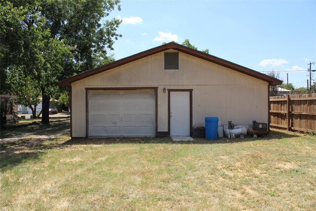 detached garage featuring fence
