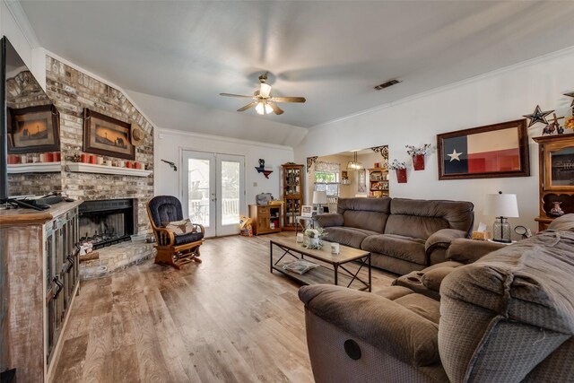 living room with ceiling fan, french doors, visible vents, crown molding, and light wood-type flooring