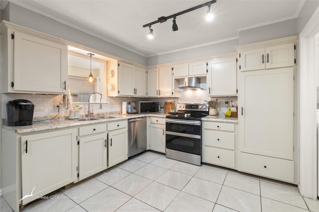 kitchen featuring wall chimney range hood, backsplash, appliances with stainless steel finishes, and a sink