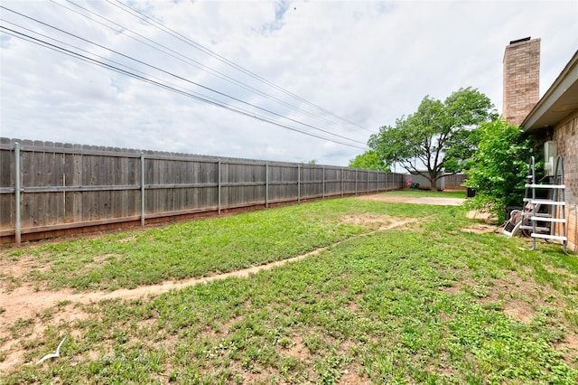view of yard with a fenced backyard