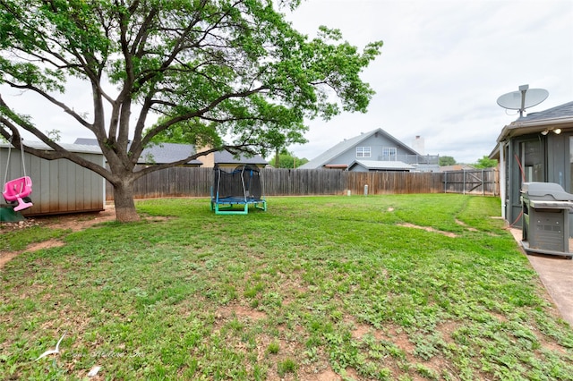view of yard featuring a fenced backyard and a trampoline