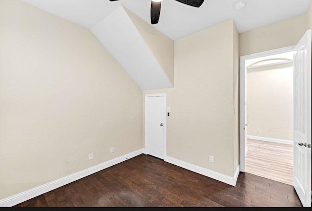 bonus room featuring baseboards, ceiling fan, and dark wood-style floors