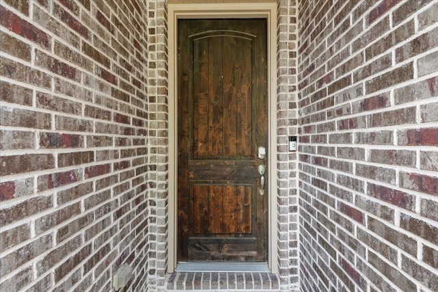 property entrance with brick siding