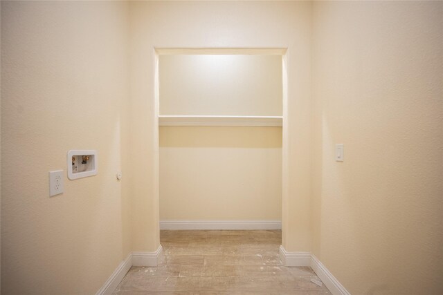 laundry area with baseboards, wood finished floors, and hookup for a washing machine
