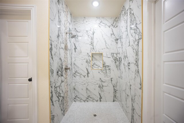 full bathroom featuring recessed lighting and tiled shower