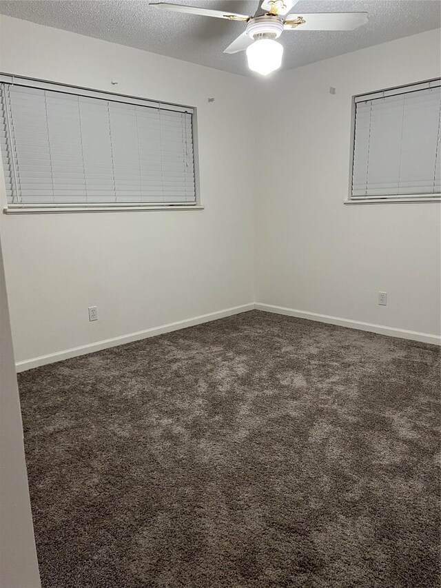 empty room featuring carpet floors, ceiling fan, baseboards, and a textured ceiling