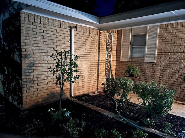 view of side of property featuring brick siding