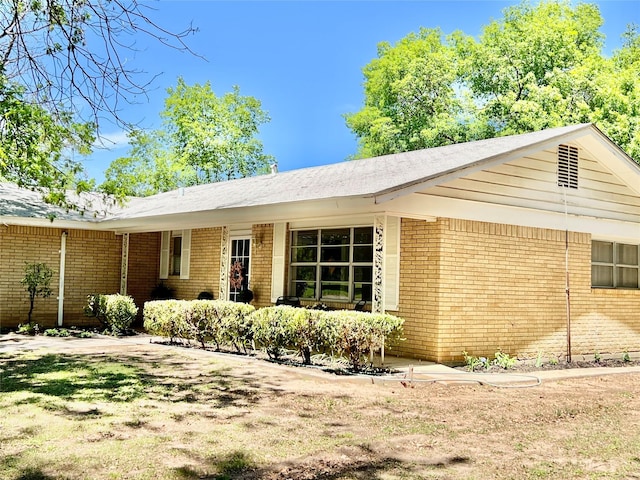 view of side of property featuring brick siding