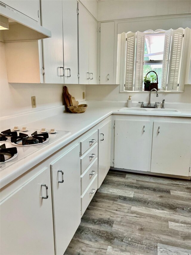 corridor with baseboards, a textured ceiling, and wood finished floors