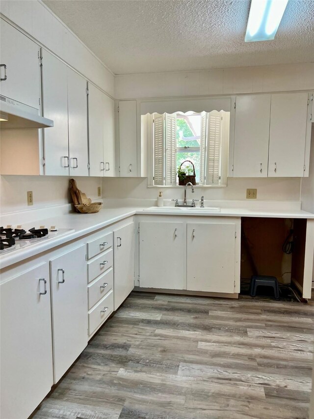 carpeted empty room with a textured ceiling, ceiling fan, and baseboards