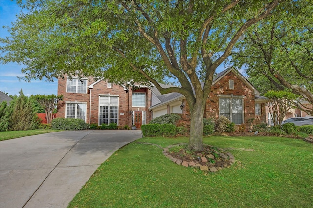 view of front of home featuring brick siding, an attached garage, driveway, and a front yard