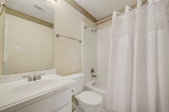 bathroom with visible vents, shower / bath combo with shower curtain, toilet, and vanity