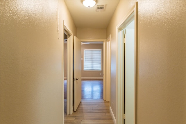 3211 Lockmoor Ln, Dallas, TX 75220 - hall with a textured wall, light wood finished floors, and visible vents