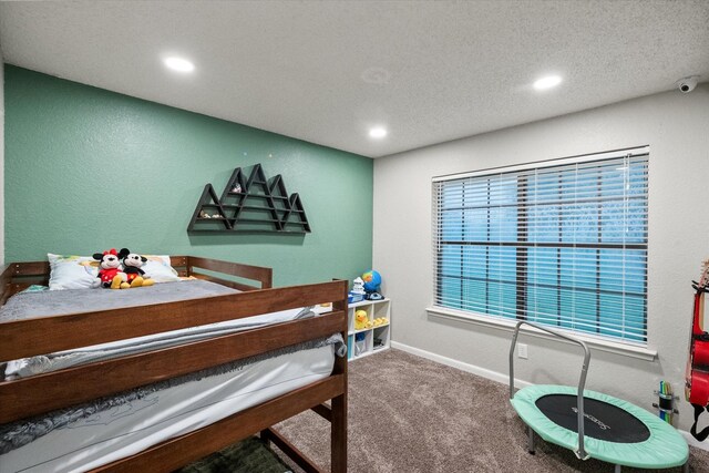 carpeted bedroom with recessed lighting, a textured ceiling, and baseboards